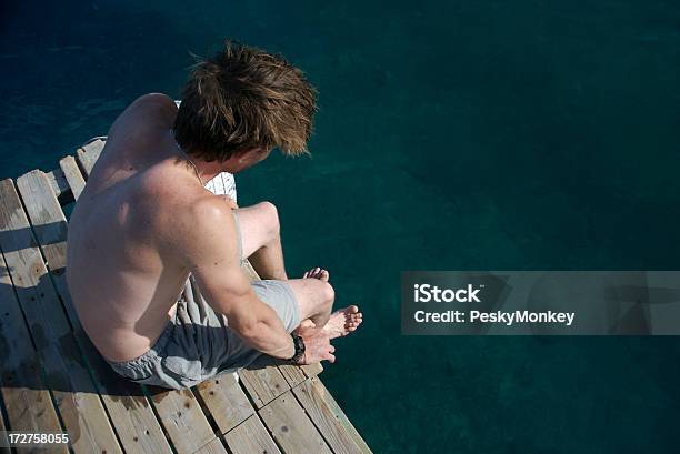 Man Sits Thinking On Summer Dock Stock Photo - Download Image Now - Adult, Adults Only, Aspirations