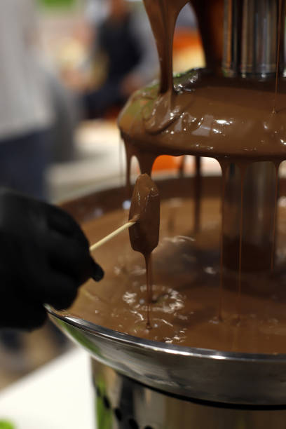 istock liquid chocolate coating a piece of fruit 1727583028