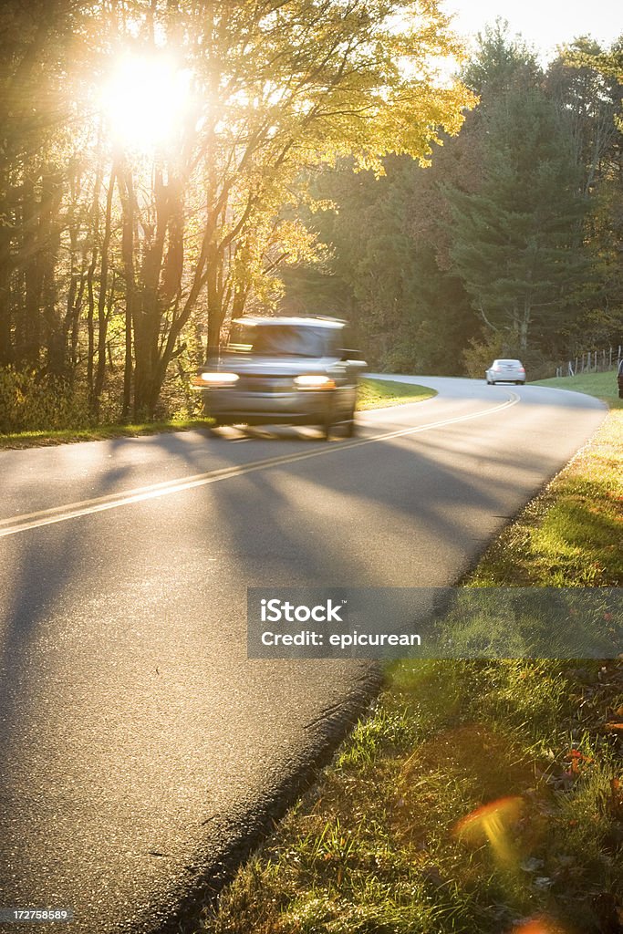 Evening Drive Setting sun on a country road. (motion blur on car - lens flares in lower right corner). Appalachia Stock Photo