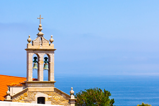 Cattail and facade of San Adrián church, seascape in Costa da Morte, A Coruña province, Galicia, Spain.