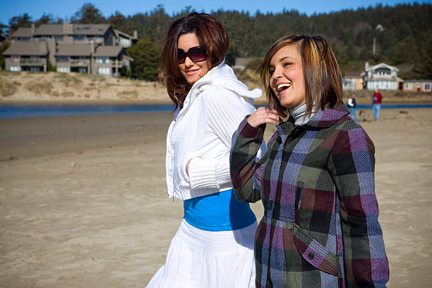 Beautiful young woman walking along the shore, laughing and hanging out. Copy space. CLICK FOR SIMILAR IMAGES AND LIGHTBOX WITH MORE BEAUTIFUL WOMEN. http://www.quavondo.com/thumbs/IStockLightboxWomen.jpg