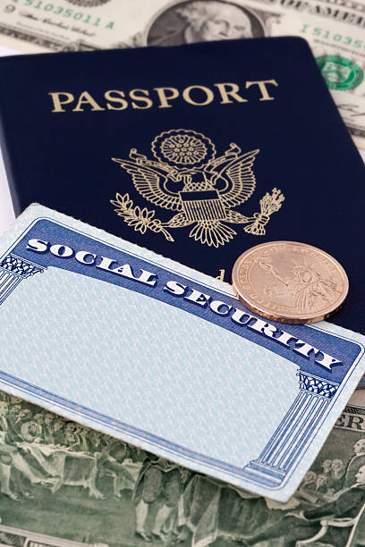 Social Security Card & Passport "Close up photograph of social security card, passport and dollar coin with paper currency, selective focus.Similar Images:" social security social security card identity us currency stock pictures, royalty-free photos & images