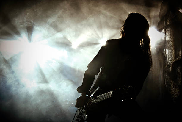 Heavy metal guitar player on stage with dramatic lights