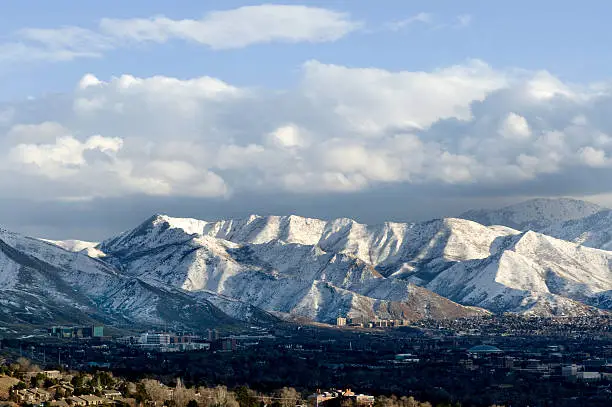 "The white jagged teeth of the Wasatch mountains loom over Salt Lake City, Utah"