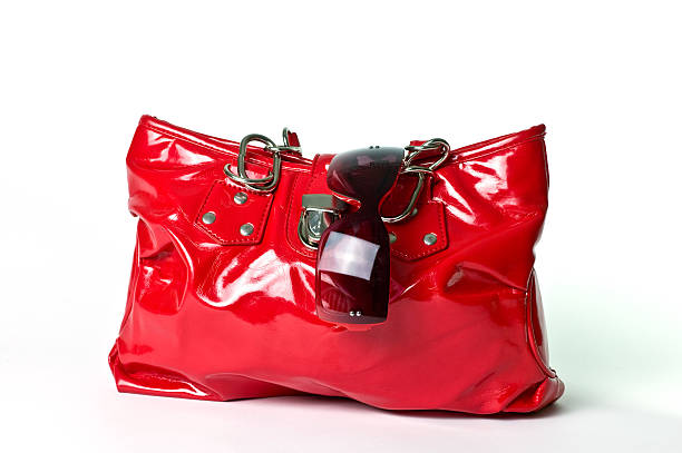 a shiny patent red leather purse with sunglasses stuck in them.Similar files: