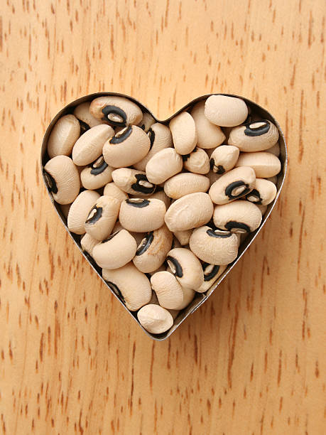 Top view of black-eyed peas inside metallic heart shaped mould