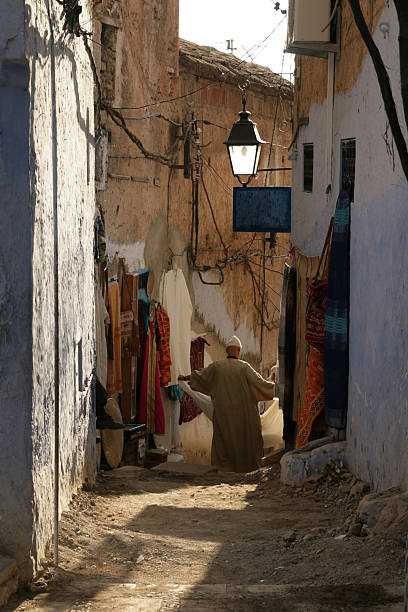 Two man folding a carpet at Street.
