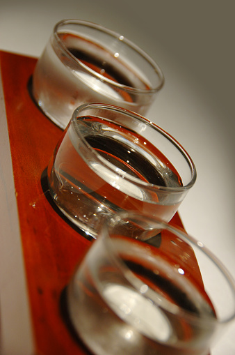 wooden tray containing sample of different types of Saki.