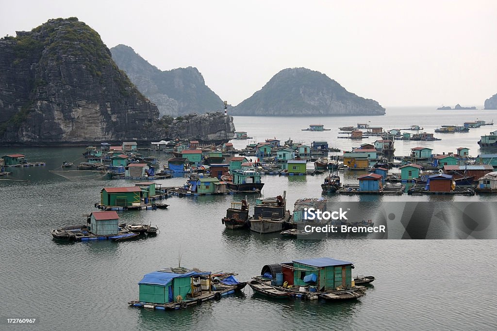 Floating village Floating village near Cat Ba island in Halong Bay, Vietnam. Fishing Boat Stock Photo