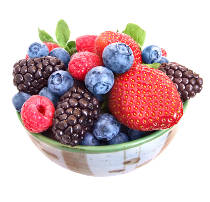 Mixed berries in a bowl : strawberries, raspberries, blueberries and blackberries. 