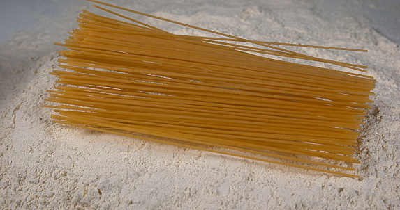 Spaghetti Pasta falling on flour