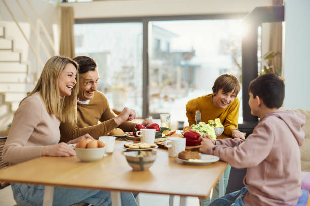 istock Cheerful family talking during breakfast at dining table. 1727613437