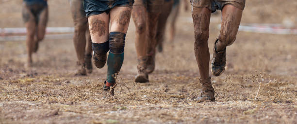 istock Group of participants in an obstacle course race running 1727613441