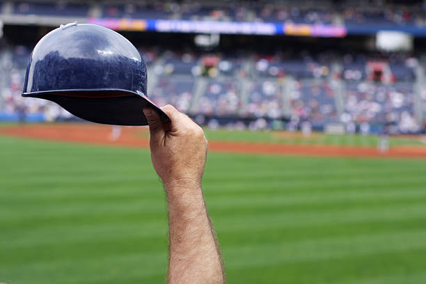 Baseball player raising his hard hat stock photo