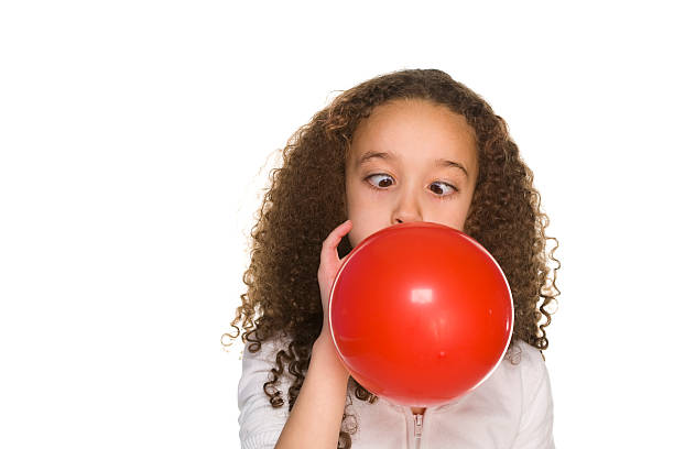istock Little girl blows up a red balloon 172761731
