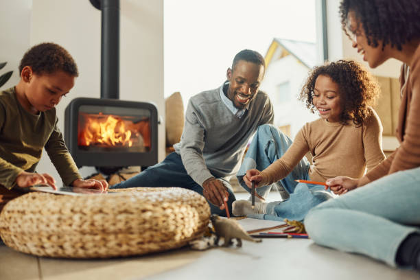 istock Happy black family having a creative time at home. 1727617937