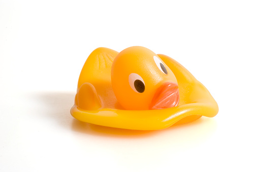 Melted rubber duck, isolated on white with clipping path. Maybe good for heat, thirst, hot summer concepts.