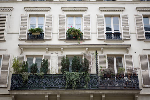istock white building with 6 balconied windows and planters 172762393