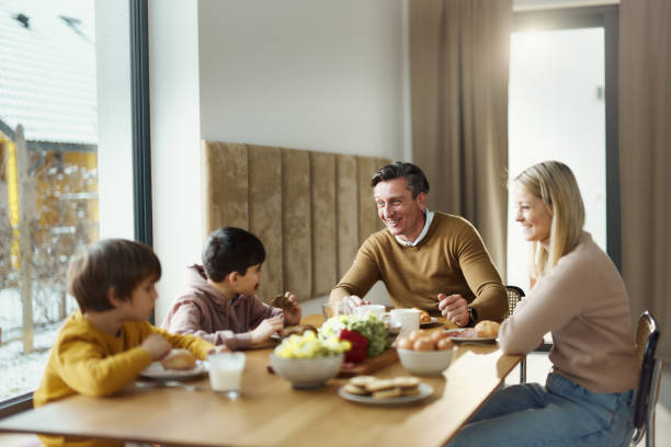 istock Happy family talking during a meal at dining table. 1727624472
