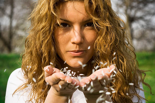 istock Attractive woman blowing a white petals 172762730