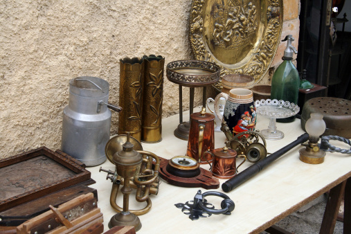 Table with some items on it in front of an antique shop
