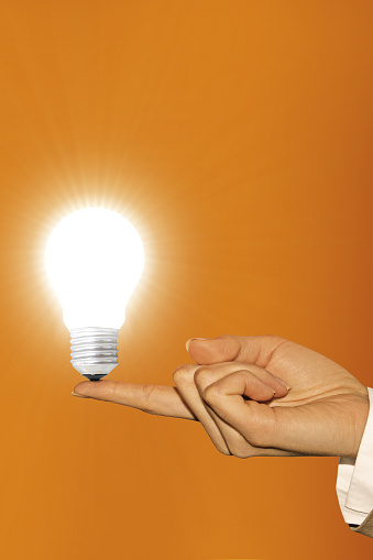 light bulb on hand as a symbol of an idea