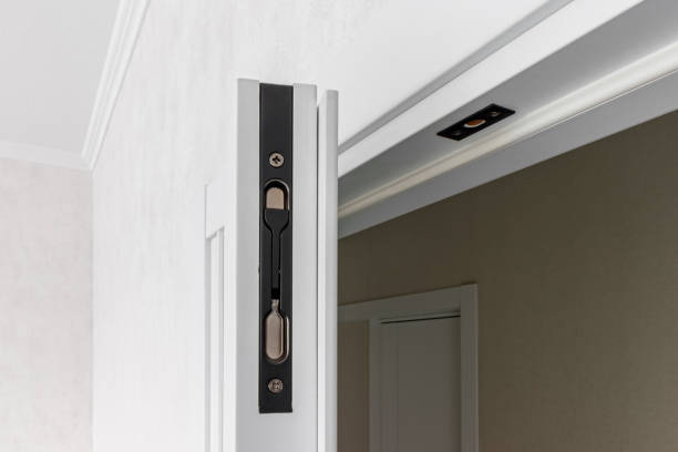 istock Modern black door handle on white wooden door in interior. Knob close-up elements 1727641628
