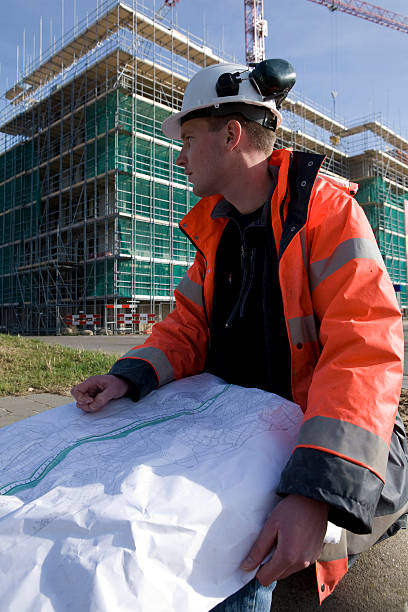 istock Young engineer on construction site in background scaffolding and crane 172764435