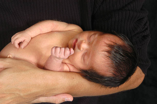 istock Baby Sleeping in Father's arms 172764545
