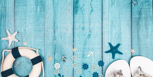 Beach accessories on blue board - summer holiday. Flat lay. Top view. Copy space