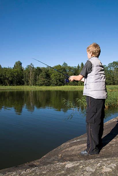 giovane fisher - sweden fishing child little boys foto e immagini stock