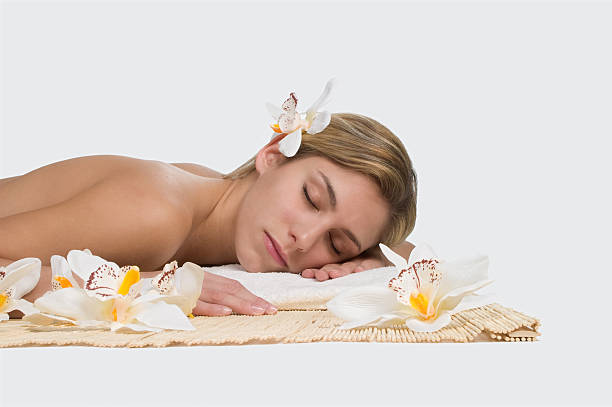 Beauty spa concept "Isolated wellness concept, beautiful woman in spa treatment with orchid flower heads and bamboo" jacraa2007 stock pictures, royalty-free photos & images