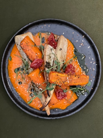 Baked vegetables. Vegetarian dinner Carrots and parsley and aivar sauce