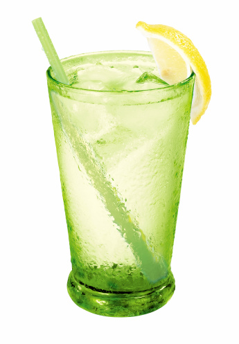 Green Cocktail with green juices, alcohol and lime wedge with isolated black background