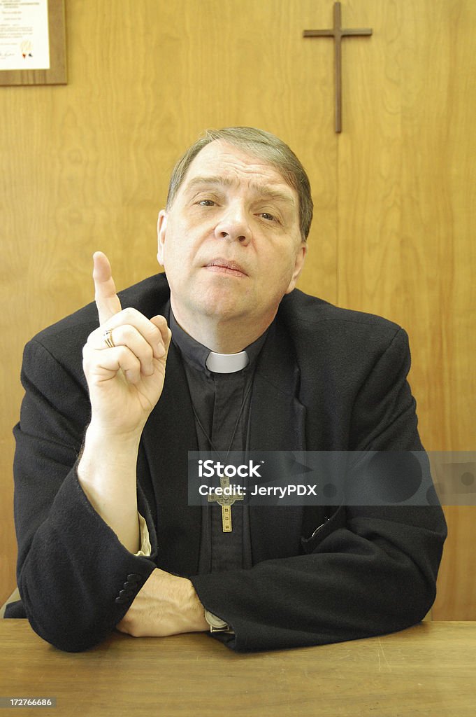 Pastor Makes A Point This pastor or priest points to heaven as he makes his point. Priest Stock Photo