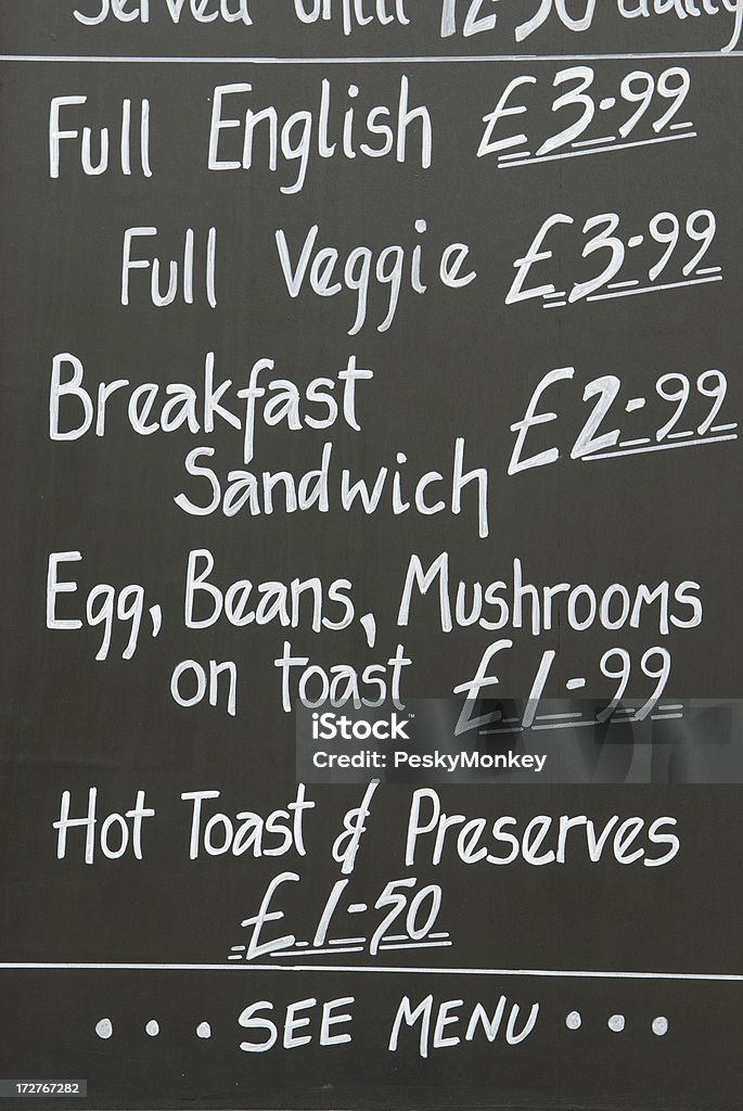 Full English Breakfast Chalkboard Menu "Black message board with white writing displays prices for breakfast options in pounds, including full English breakfast and hot toast" Bean Stock Photo