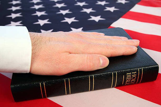 istock Under Oath Concept: Hand on Bible with American Flag Background 172767422