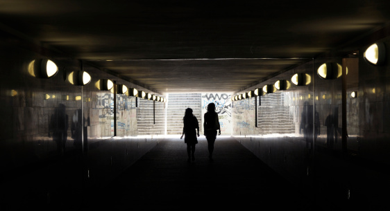 Two people in underground tunnel