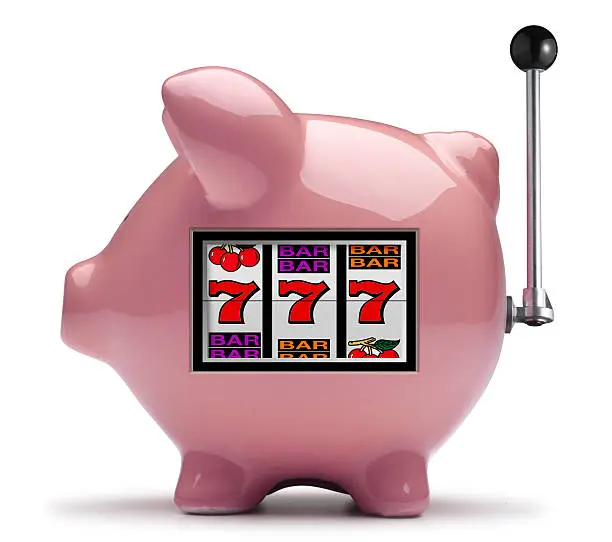 Photo of Pink piggy bank slot machine on white background