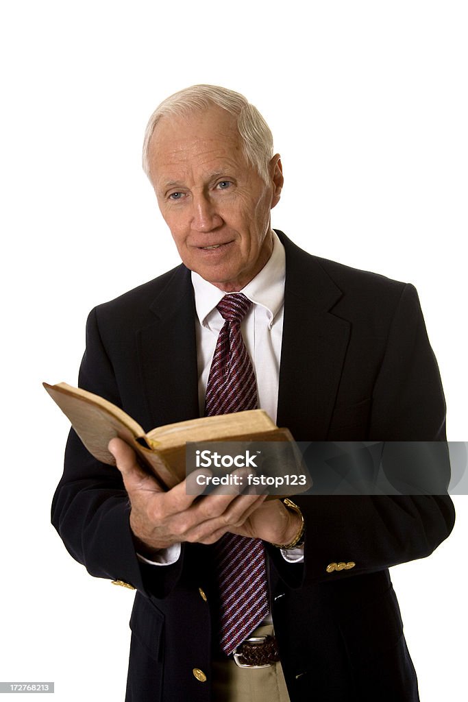 Man in suit with open book Man in suit, he is reading from an open book.   Bible Stock Photo
