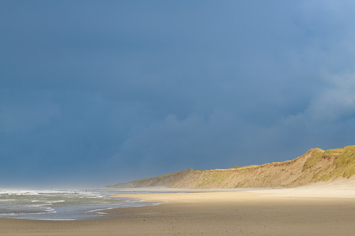 Waves at the beach on Texel island in the Wadden sea region in the North of The Netherlands during a stormy autumn morning.