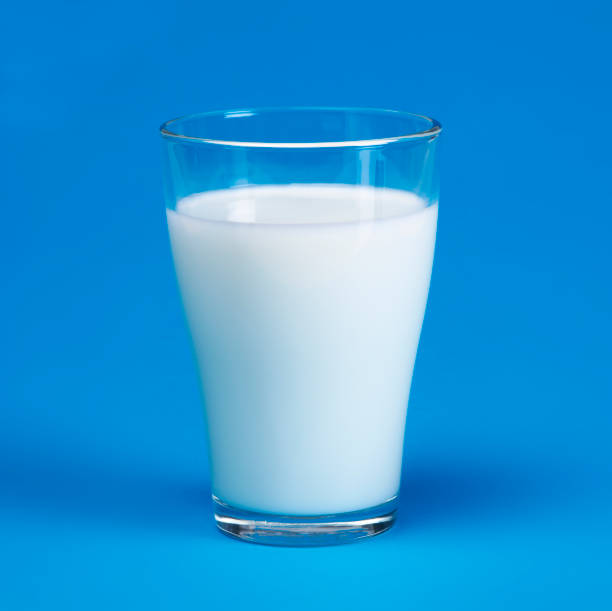 istock Glass of milk on blue background 172769449