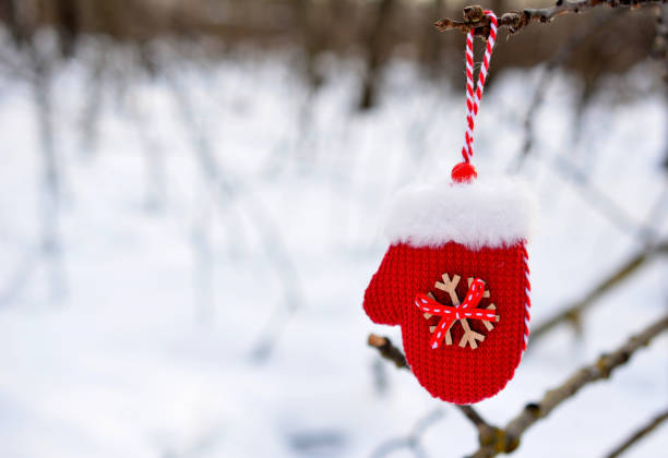 istock red toy mitten hanging on the twig with snowy forest on background copy space 1727699424