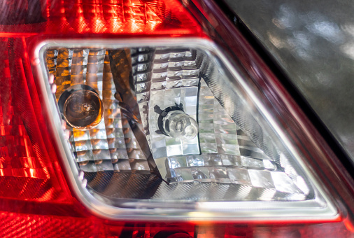 Close-up tail light, headlight and bulb lamps of a car.
