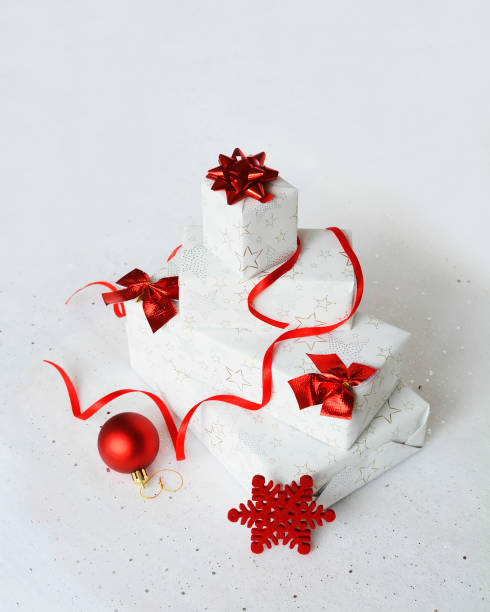 istock Christmas gift composition. White and red winter decorations on white background. Christmas,  new year concept. Presents with boxes, ribbon and ball. Front view. Card, calendar and advent concept. 1727706649
