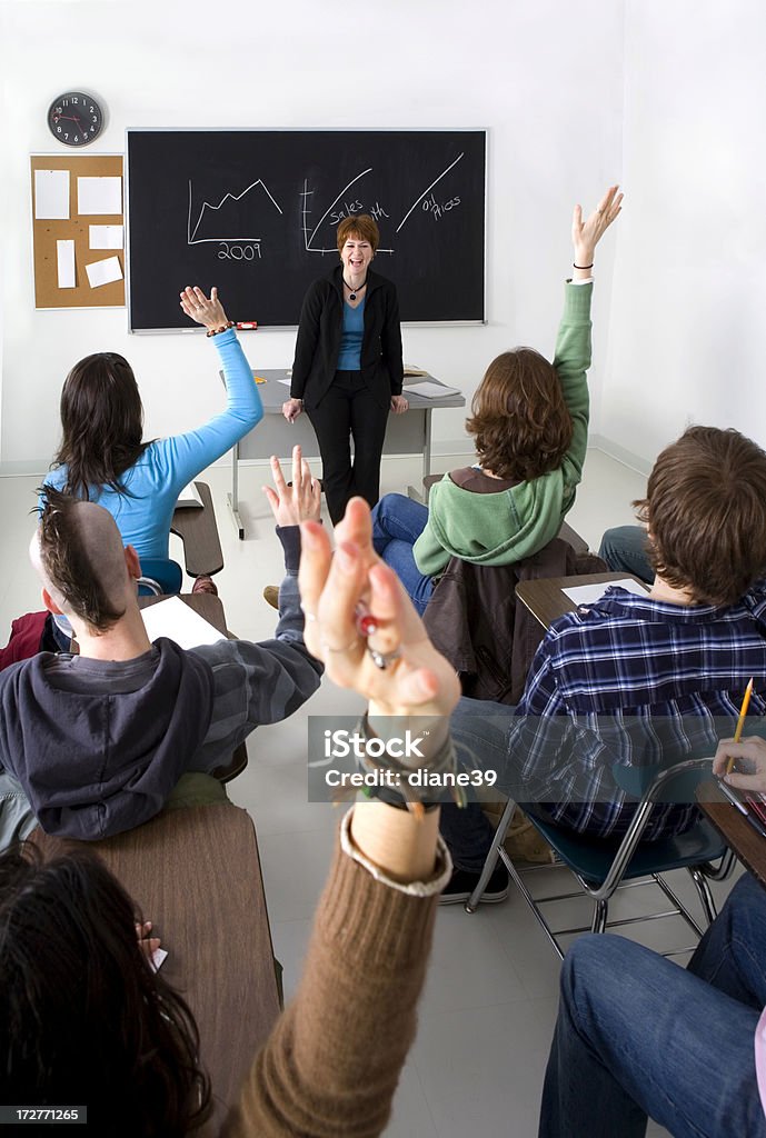 enthusiastic class A class enthusiastically responds to a question in class. Classroom Stock Photo
