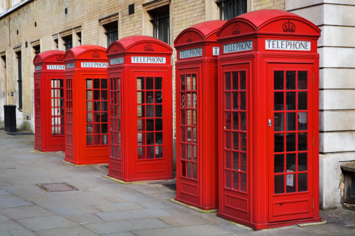 Five old style phone boxes in central London.
