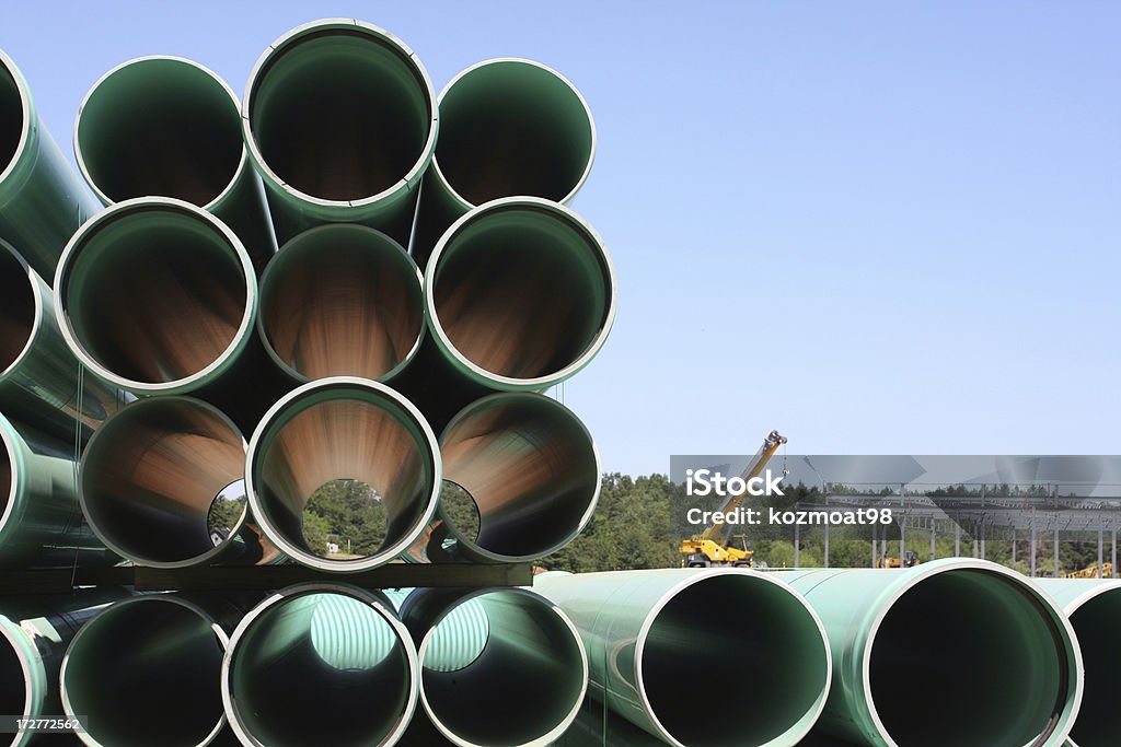 Construction Industry Stacked PVC pipe sections on a construction site. Close-up Stock Photo