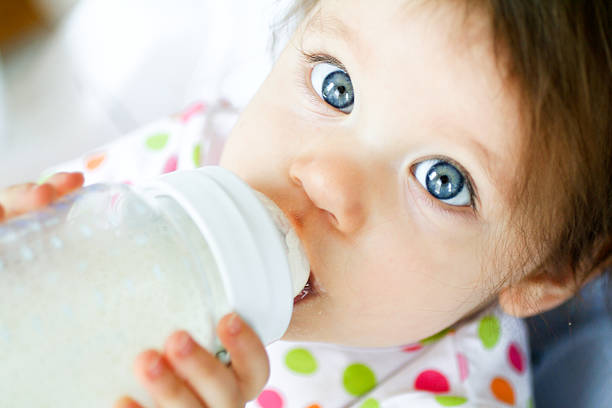 Baby with bottle stock photo