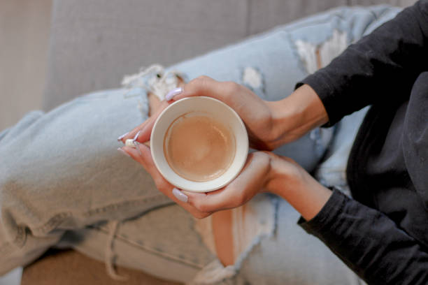 istock Young woman holding a cup of coffee 1727735754